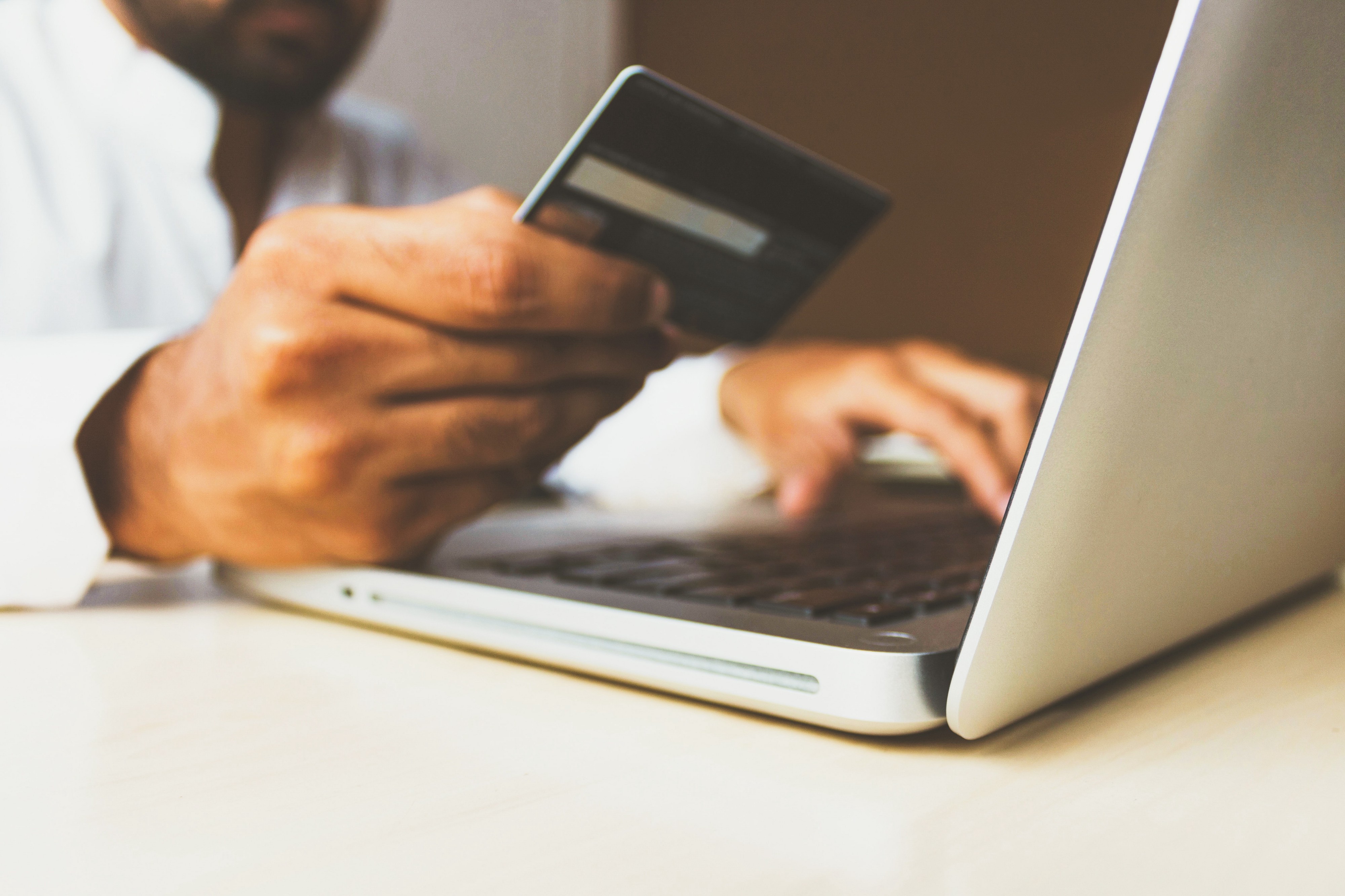 User on computer with credit card — Photo by rupixen.com on Unsplash